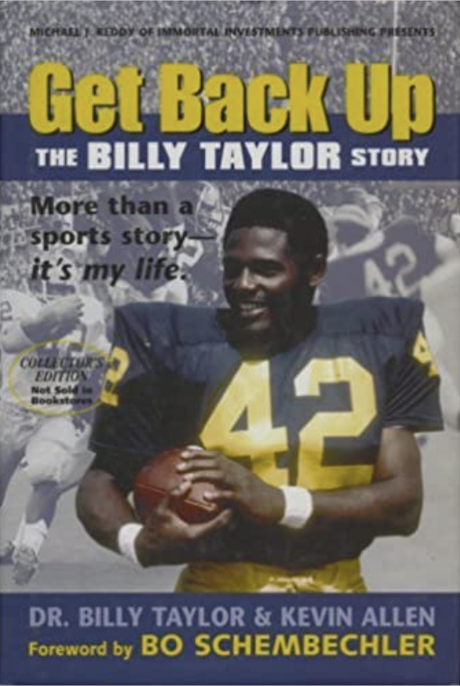 Billy Taylor wearing number 42 jersey and holding a football helmet