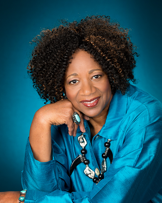 Betty Brown Chappell in a blue shirt facing the camera