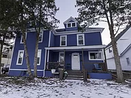 blue house at 144 Hill with snow in front yard