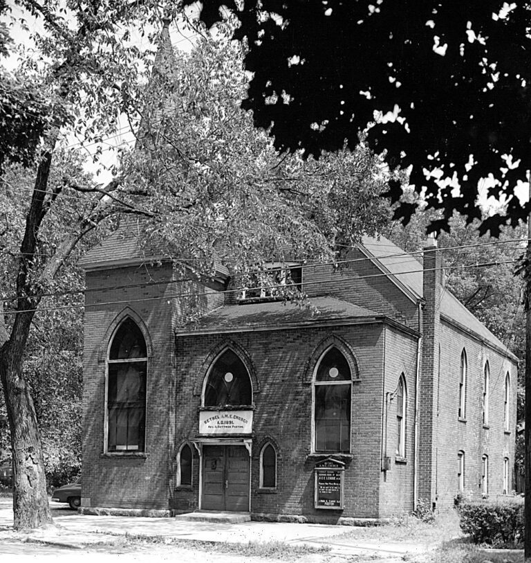 church facing street with trees surrounding it