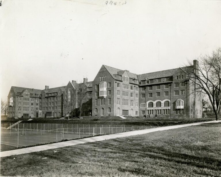 Large dormitory in black and white, situated on a hill.