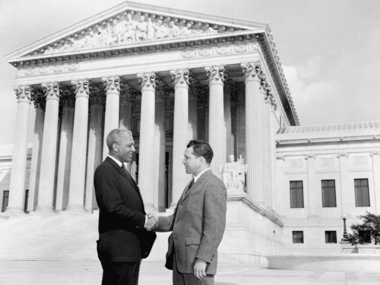 Belford Lawson shaking hands in front of the Supreme Court.